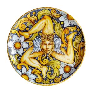 A handmade Sicilian wall plate featuring a Trinacria, the three-legged symbol of Sicily. Handmade in Caltagirone, Italy