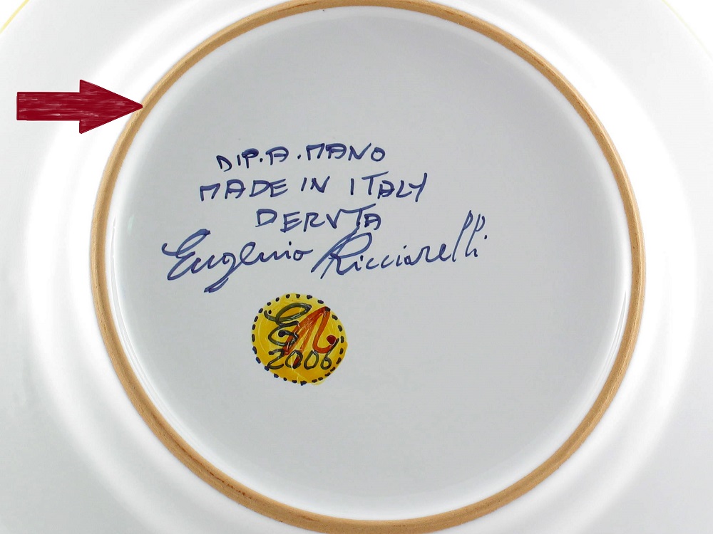 Bottom of a hand-painted Deruta dinner plate with Ricciarelli's signature. The unglazed area on the bottom of a ceramic piece helps identify the type of clay used by the ceramicist