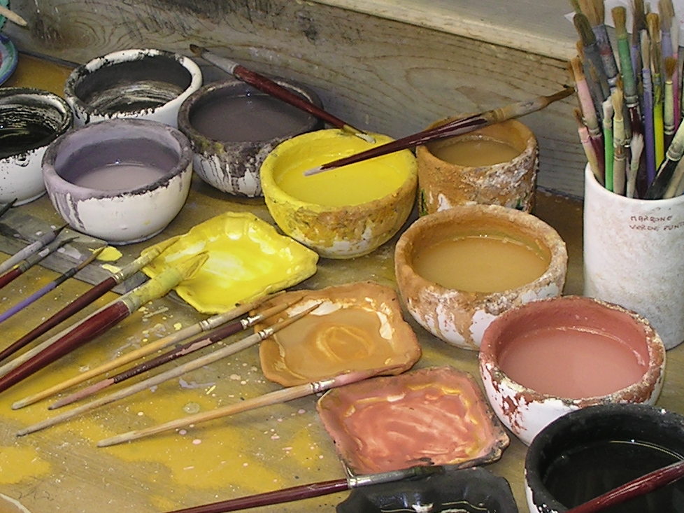 A Deruta artisan's desk with ceramic glazes and brushes