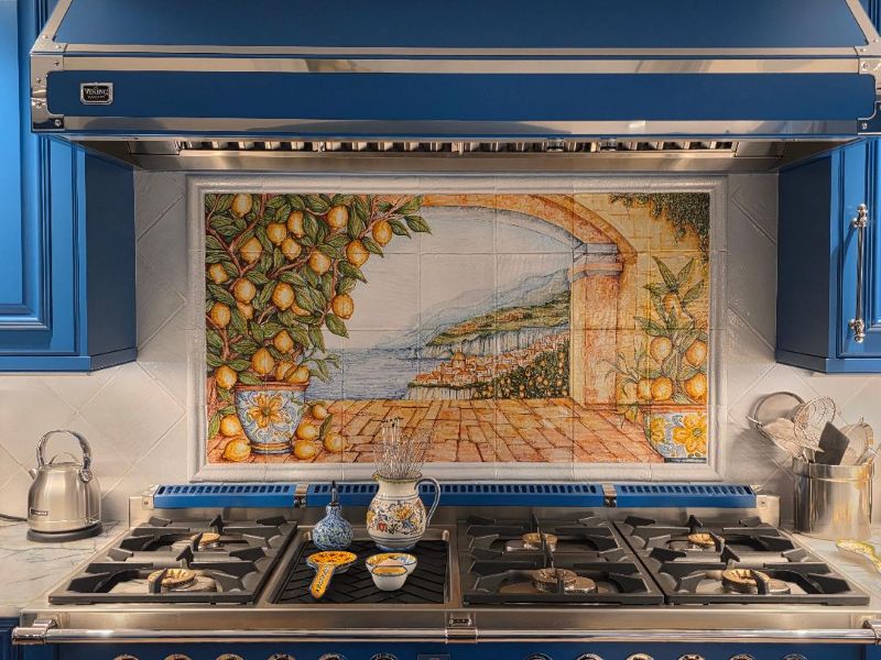 Hand-painted Italian backsplash panel featuring a stunning coastal landscape with lemons, installed above a stove.
